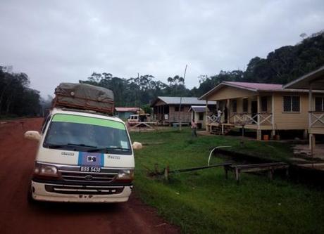 A van parked on a dirt road

Description automatically generated