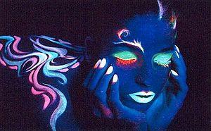 Fluorescent makeup used for artistic effect.