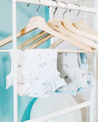 Ropa de bebé colgada en perchas Ropa de bebé colgada en perchas