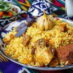 a plate of rice with meat and vegetables