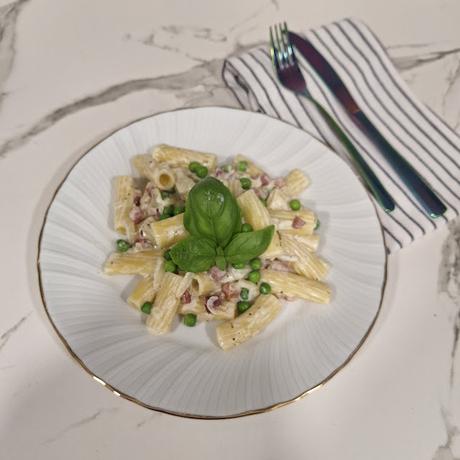 Pasta con jamon y guisantes en salsa de queso